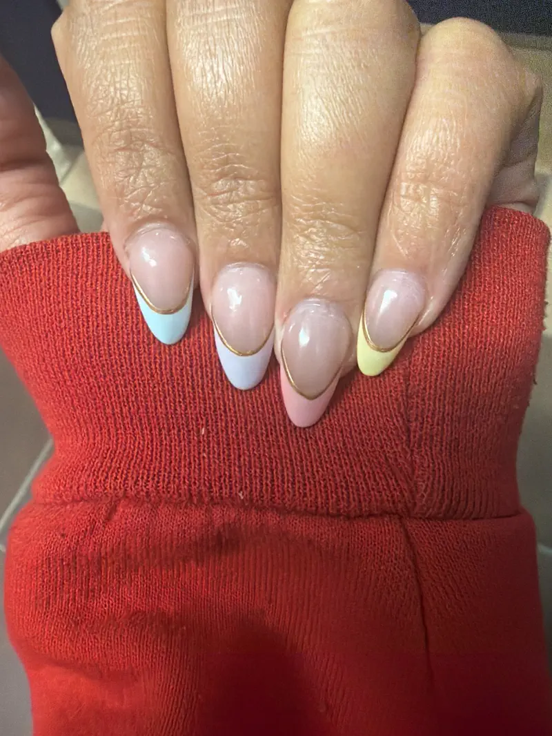 Pastel French tips, each edged with a thin gold line