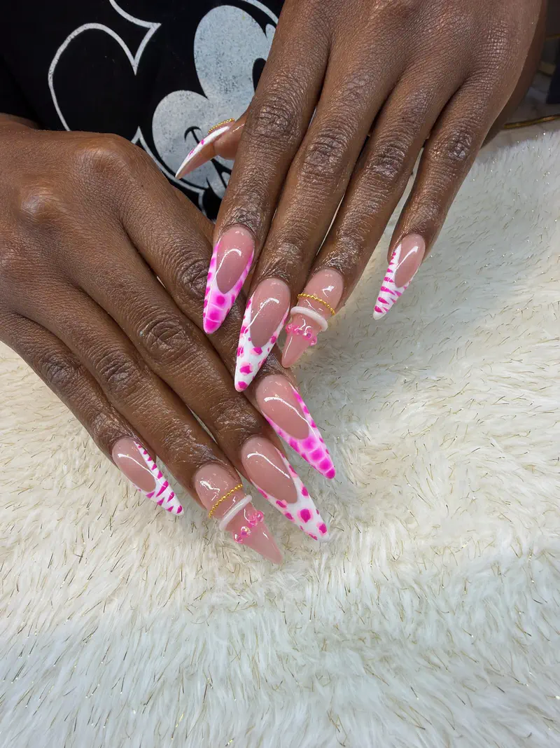 Long almond nails in a pink-and-white French with hot pink spots